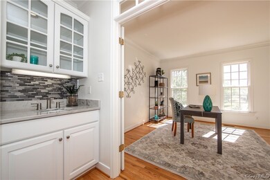 The classy wet bar creates an inviting transition into the Family Room.