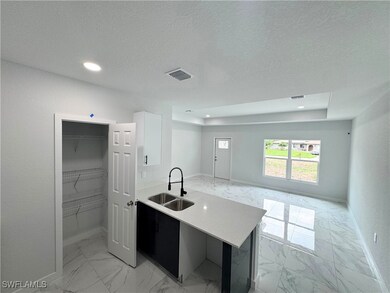 Kitchen featuring light marble finish flooring, li