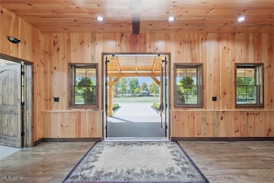 Entryway featuring wood walls, wood finished floors, recessed lighting, and wood ceiling