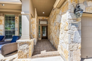 Doorway to property with stone siding and a porch