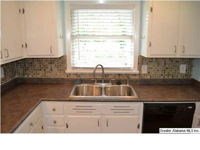 Close-up of the white cabinets, glass tile backspl