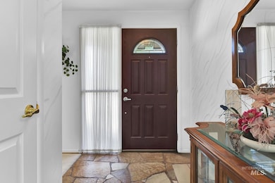 Foyer with stone tile floors and baseboards