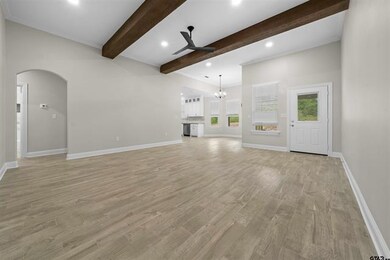 Unfurnished living room with ceiling fan with nota