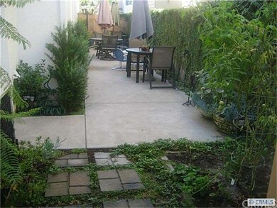 Side yard patio extends the full length of lot
