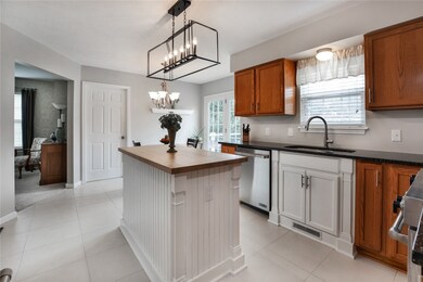Kitchen with newer island and lighting fixtures