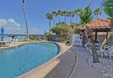 View of swimming pool featuring a patio and a water view