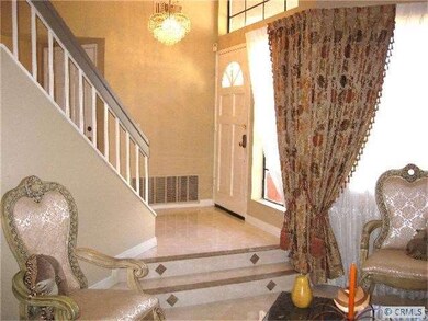 Formal entrance boasts porcelain tile floors with 