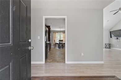 Foyer with ceiling fan and hardwood / wood-style f
