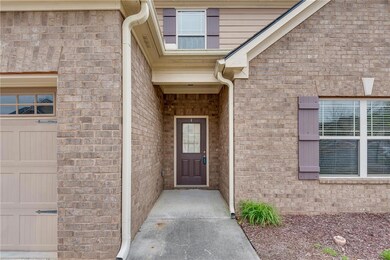 View of exterior entry featuring brick siding