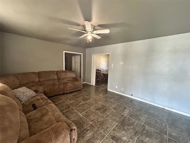 Unfurnished living room with baseboards and ceilin
