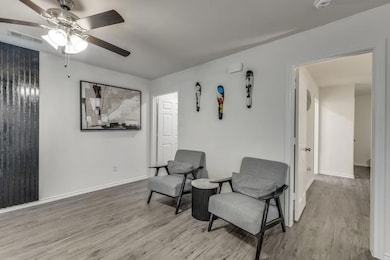 Sitting room with ceiling fan and light hardwood /