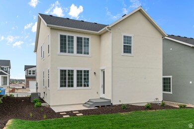 Rear view of property with stucco siding and a yard