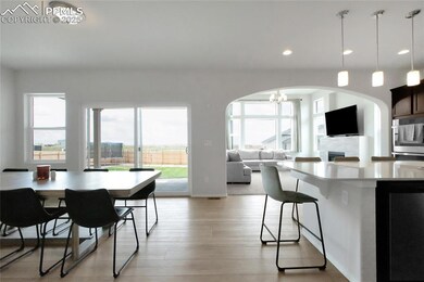 Kitchen featuring arched walkways, a chandelier, light wood-style flooring, healthy amount of natural light, and recessed lighting