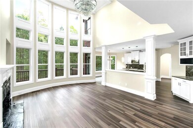Unfurnished living room with decorative columns, a