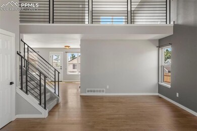 Entrance foyer with wood-type flooring and a tower