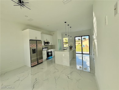 Kitchen with appliances with stainless steel finis