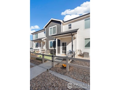 The fully fenced in front yard has new artificial turf and sandbox.