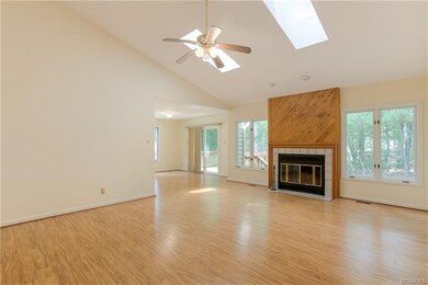 Beautiful wood floors a vaulted ceiling and a fire