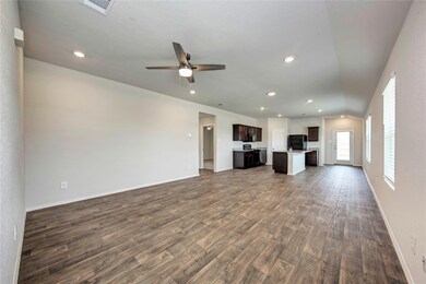 Unfurnished living room featuring dark wood-style