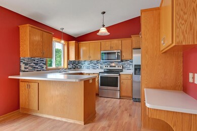 The kitchen features lovely oak cabinetry, a tiled
