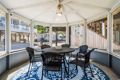 Sunroom / solarium featuring lofted ceiling