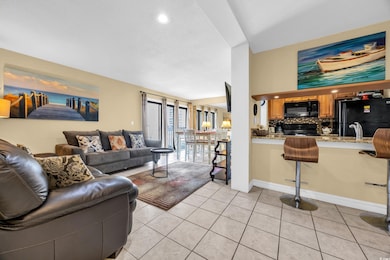 Living area featuring light tile patterned floors and recessed lighting