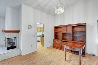 Office area featuring a tile fireplace, baseboards