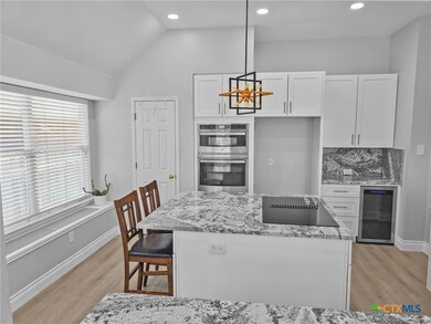 Big window with window seat keeps this kitchen bri