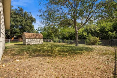 View of back yard featuring a storage shed