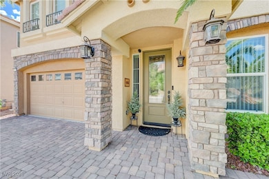 Doorway to property featuring a balcony, stucco si