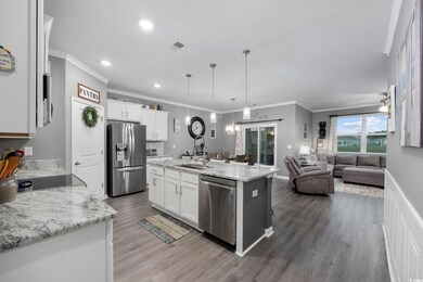 Kitchen featuring a center island with sink, penda
