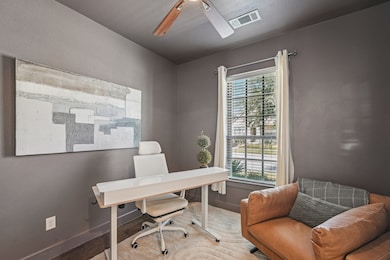 Office space with wood finished floors and ceiling fan