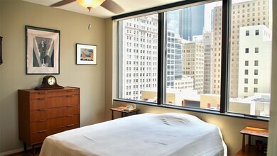 Bedroom with multiple windows and ceiling fan
