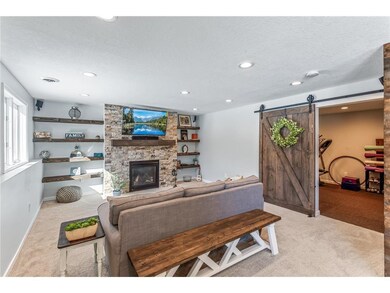 Lower level family room with barn door, gas firepl