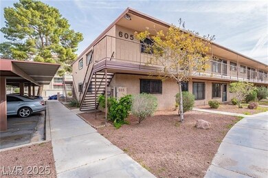 View of front facade with stairway and stucco siding