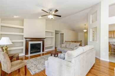 Built in shelving, a gas fireplace, an open stairc