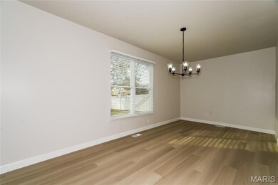 Unfurnished room with a chandelier and wood finished floors