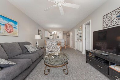 Carpeted living room with ceiling fan with notable
