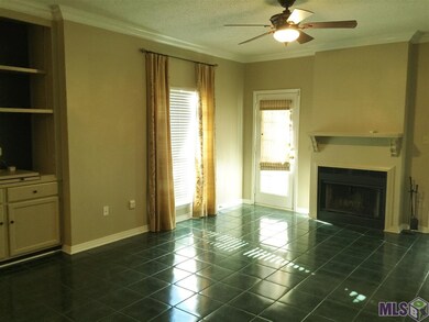 Livingroom view 2 w/fireplace and patio