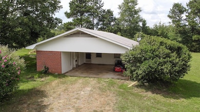 View of property exterior featuring a carport