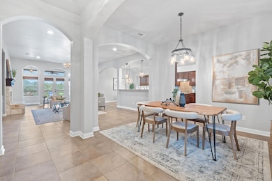 Dining space featuring a chandelier, arched walkw