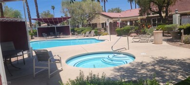 Community pool featuring a hot tub and a patio