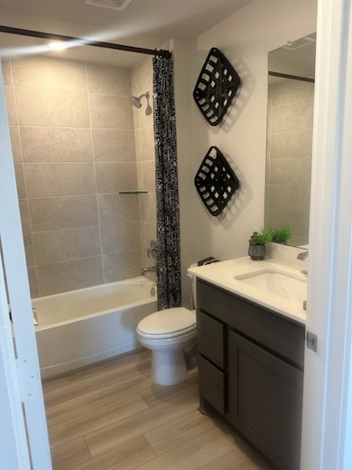 Bathroom featuring vanity, shower / bath combo, to
