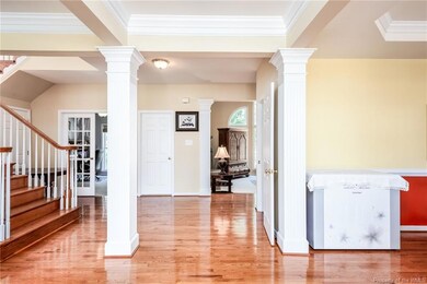 Foyer to the Great Room has hardwood floors, columns and crown molding.