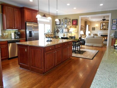 Alt' view of kitchen. Home features beautiful hardwood floors