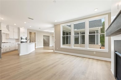 Unfurnished living room with visible vents, orname