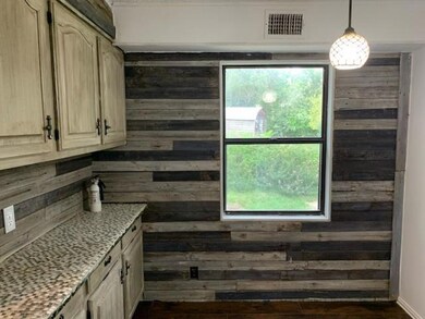 Kitchen with wood walls, a wealth of natural light