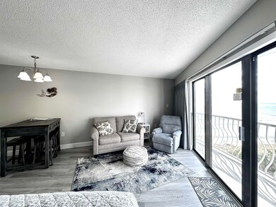 Living room with a textured ceiling, an inviting c