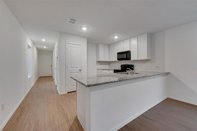 Kitchen featuring white cabinets, light wood-type 