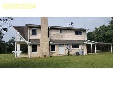 Right view of property with a yard and central AC 